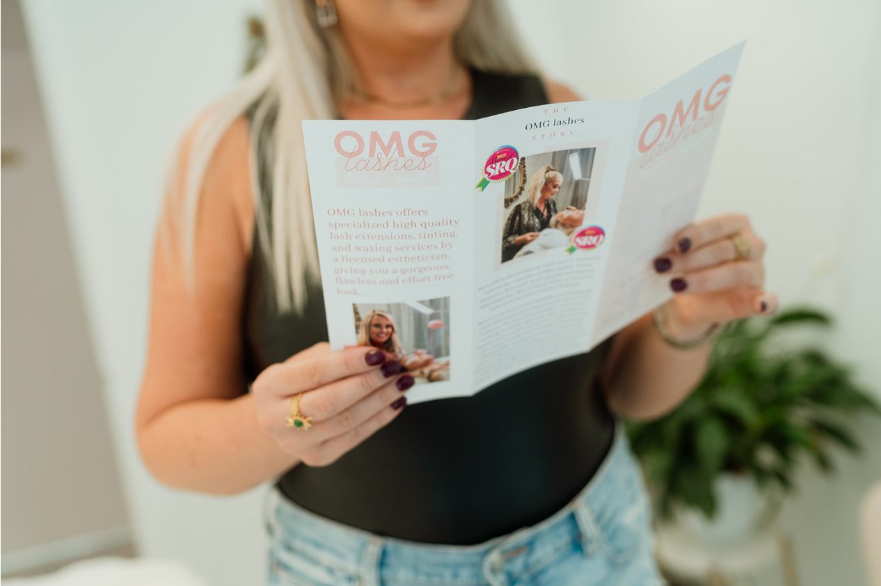 Olivia reading the OMG Lashes studio brochure
