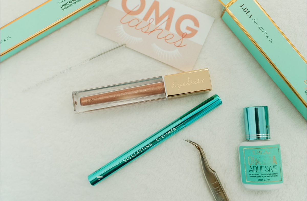 Lash products and branding on a studio table at OMG Lashes